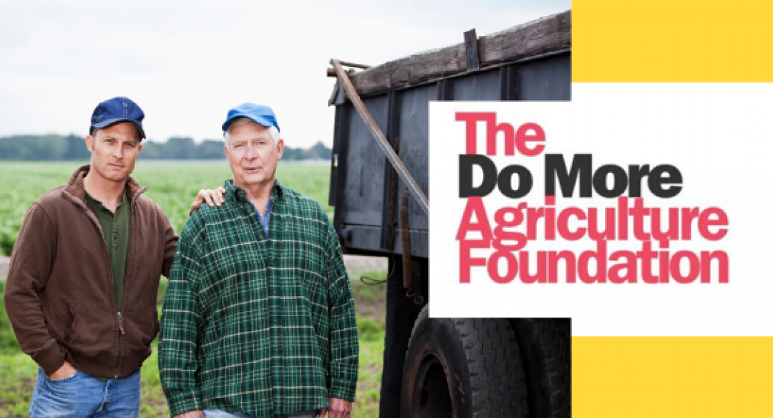 Image of two farmers standing near trucks with The Do More Agriculture Foundation logo 